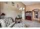 Elegant living room showcasing a chaise lounge and built-in cabinetry at 15547 W Magnolia St, Goodyear, AZ 85338