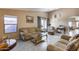 Living room featuring neutral-toned furniture and tile floors at 15547 W Magnolia St, Goodyear, AZ 85338