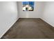 Empty bedroom with carpeted floor and a window at 1948 W Busoni Pl, Phoenix, AZ 85023