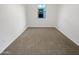 Spacious bedroom with neutral carpeting and large window at 1948 W Busoni Pl, Phoenix, AZ 85023