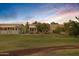 Home with backyard view overlooking a green golf course at 20566 N Lemon Drop Dr, Maricopa, AZ 85138