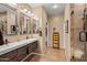 Spa-like bathroom with double sinks, large mirror and walk-in shower at 20566 N Lemon Drop Dr, Maricopa, AZ 85138