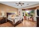 Main bedroom with wood flooring and large window overlooking backyard at 20566 N Lemon Drop Dr, Maricopa, AZ 85138