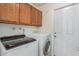 Laundry room with washer, dryer, and cabinets at 2325 E Hermosa Dr, Tempe, AZ 85282