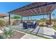 Covered patio area with pergola and seating for four at 2347 N 169Th Ave, Goodyear, AZ 85395