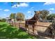 Brown horse in a fenced pasture with a sheep at 2975 E Campbell Rd, Gilbert, AZ 85234