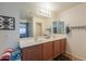 Bathroom with double vanity and large mirror at 40748 W Chambers Dr, Maricopa, AZ 85138