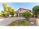 Front yard view of a one-story house with landscaping and a driveway at 41229 W Laramie Rd, Maricopa, AZ 85138