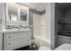 Main bathroom with white vanity, tub shower, and storage at 44 S Hawes Rd # A15, Mesa, AZ 85208