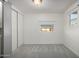 Simple bedroom with grey carpet and large sliding closet doors at 44 S Hawes Rd # A15, Mesa, AZ 85208