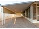 Covered carport with gravel parking and storage shed at 44 S Hawes Rd # A15, Mesa, AZ 85208