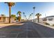 Mobile home community with palm trees and a paved road at 44 S Hawes Rd # A15, Mesa, AZ 85208
