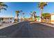 Sun-drenched street lined with mobile homes and palm trees at 44 S Hawes Rd # A15, Mesa, AZ 85208