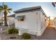 Rear view of a white mobile home with landscaping at 44 S Hawes Rd # A15, Mesa, AZ 85208