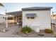 White mobile home with covered patio and landscaping at 44 S Hawes Rd # A15, Mesa, AZ 85208