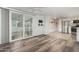 Bright living room with vinyl plank flooring and sliding glass door leading to backyard at 44 S Hawes Rd # A15, Mesa, AZ 85208