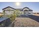 Newly built home with a two-car garage and desert landscaping at 8245 W Pica Dr, Arizona City, AZ 85123