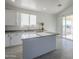 Modern kitchen featuring a large island and granite countertops at 8245 W Pica Dr, Arizona City, AZ 85123