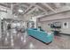 Community lounge with teal sofa and large TV at 114 W Adams St # 506, Phoenix, AZ 85003