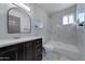 Modern bathroom with marble tile, bathtub, and vanity at 17842 N 43Rd St, Phoenix, AZ 85032