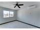 Bright bedroom with ceiling fan, large window, and tile flooring at 17842 N 43Rd St, Phoenix, AZ 85032