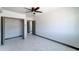 Spacious bedroom with ceiling fan, large closet, and tile flooring at 17842 N 43Rd St, Phoenix, AZ 85032