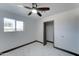 Bright bedroom with ceiling fan, window, and large closet at 17842 N 43Rd St, Phoenix, AZ 85032