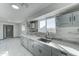 Renovated kitchen with gray cabinets, stainless steel sink, and tile flooring at 17842 N 43Rd St, Phoenix, AZ 85032