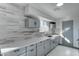 Modern kitchen with gray cabinets, quartz countertops, and tile backsplash at 17842 N 43Rd St, Phoenix, AZ 85032