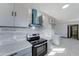 Modern kitchen with stainless steel range and gray cabinetry at 17842 N 43Rd St, Phoenix, AZ 85032