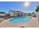 Backyard with a pool, grass area, and a view of the house exterior with red tile roof at 2326 N Rose St, Mesa, AZ 85213