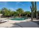 Relaxing kidney-shaped pool surrounded by lush landscaping at 24209 N 87Th St, Scottsdale, AZ 85255