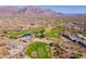 Aerial view of a golf course community nestled in a mountainous region at 3877 S Veronica Ln, Gold Canyon, AZ 85118