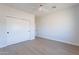Light and airy bedroom with wood-look floors and double doors to closet at 3877 S Veronica Ln, Gold Canyon, AZ 85118