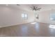 Spacious bedroom with wood-look floors, ceiling fan and large windows at 3877 S Veronica Ln, Gold Canyon, AZ 85118