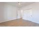 Bright bedroom with wood-look floors, ceiling fan, and double doors to closet at 3877 S Veronica Ln, Gold Canyon, AZ 85118