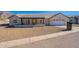 Modern house exterior, showcasing the front entrance and driveway at 3877 S Veronica Ln, Gold Canyon, AZ 85118