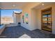 Covered front porch with mountain views and modern wood door at 3877 S Veronica Ln, Gold Canyon, AZ 85118
