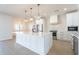 Bright kitchen featuring white cabinetry, an island, and stainless steel appliances at 3877 S Veronica Ln, Gold Canyon, AZ 85118