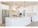 Modern kitchen with white cabinets, stainless steel appliances, and quartz countertops at 3877 S Veronica Ln, Gold Canyon, AZ 85118
