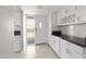Updated kitchen with white cabinets and black countertops at 4701 N 68Th St # 248, Scottsdale, AZ 85251