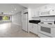 Modern kitchen with white cabinets, black counters, and view of living room at 4701 N 68Th St # 248, Scottsdale, AZ 85251