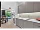 Modern wet bar with gray cabinets, white countertops, and a sleek sink at 6521 N 4Th St, Phoenix, AZ 85012