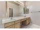 Double vanity bathroom with light wood cabinets and tile flooring at 6653 E Sugarloaf St, Mesa, AZ 85215