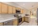 Modern kitchen with stainless steel appliances and light wood cabinets at 6653 E Sugarloaf St, Mesa, AZ 85215