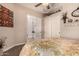 Bedroom with a view of the attached bathroom and ceiling fan at 9246 W Molly Ln, Peoria, AZ 85383