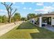 Large backyard with grassy area, raised garden beds, and covered patio at 1101 N Christa Way, Tolleson, AZ 85353