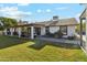Spacious backyard with covered patio, grassy area, and mature trees at 1101 N Christa Way, Tolleson, AZ 85353