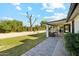 Landscaped backyard with patio, grassy area, and raised garden beds at 1101 N Christa Way, Tolleson, AZ 85353