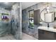 Clean bathroom with a walk-in shower, window and modern vanity at 1101 N Christa Way, Tolleson, AZ 85353